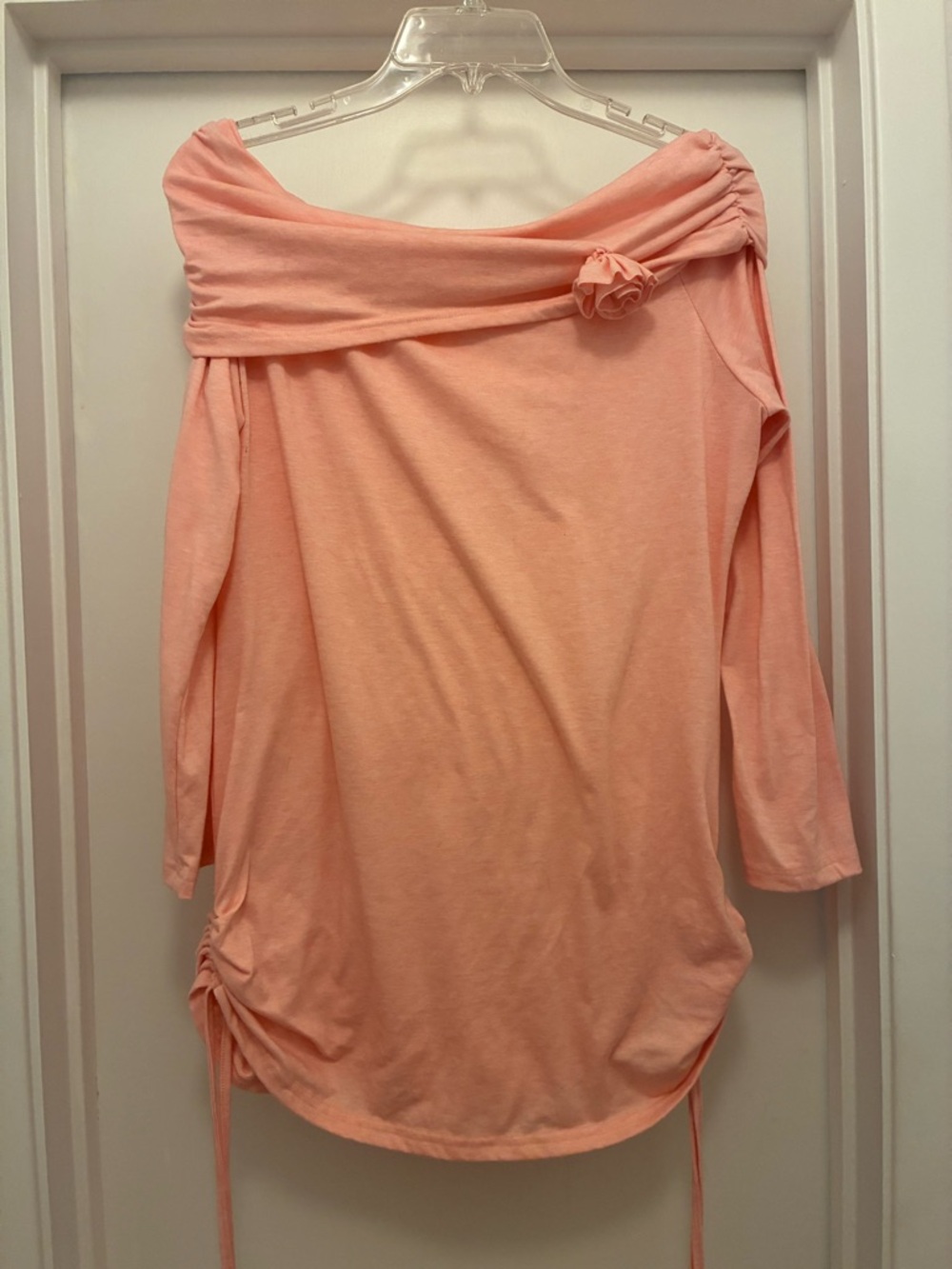 Off-Shoulder Peach Knit Top with Decorative Rosette
